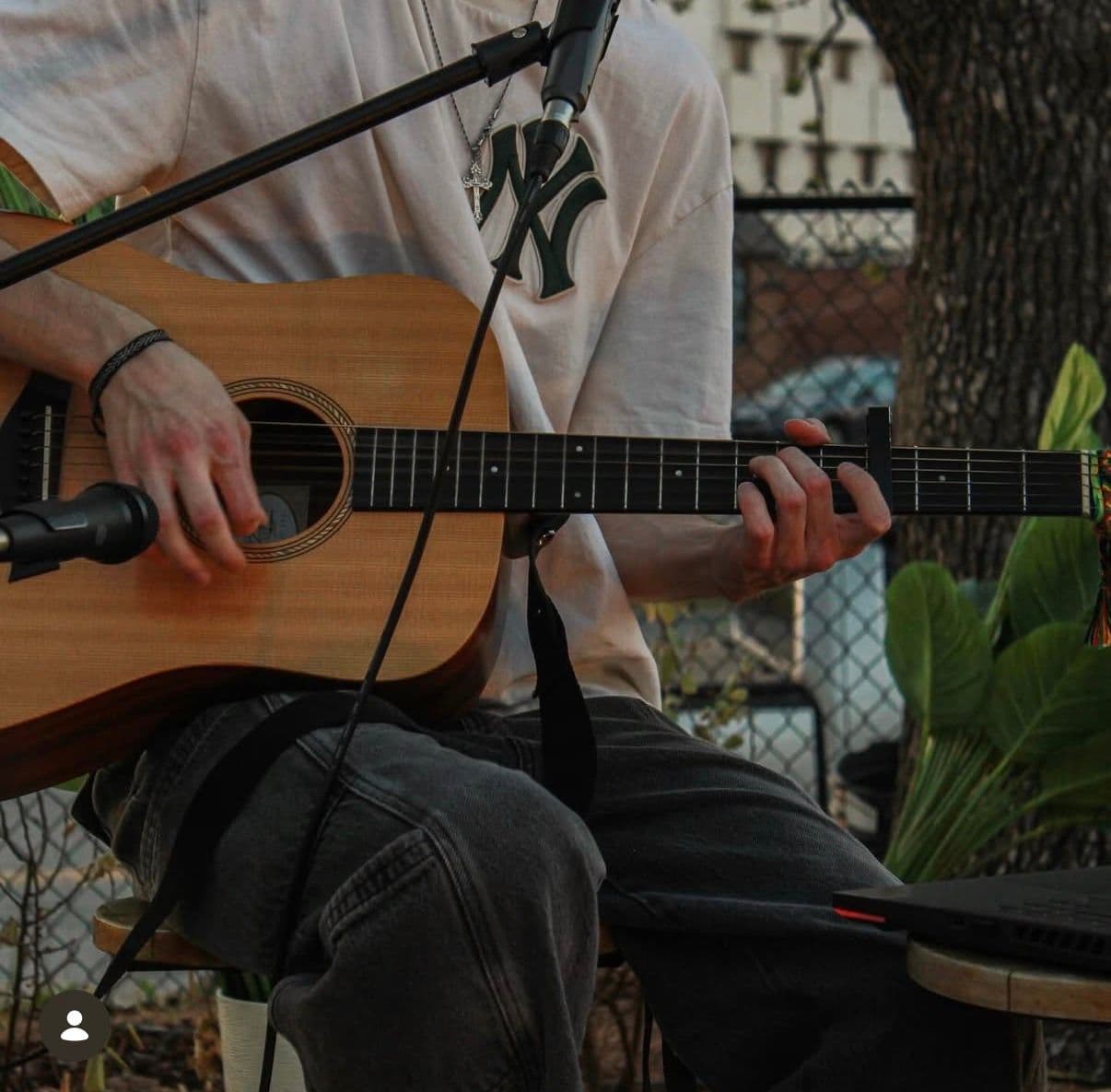 man playing guitar outside